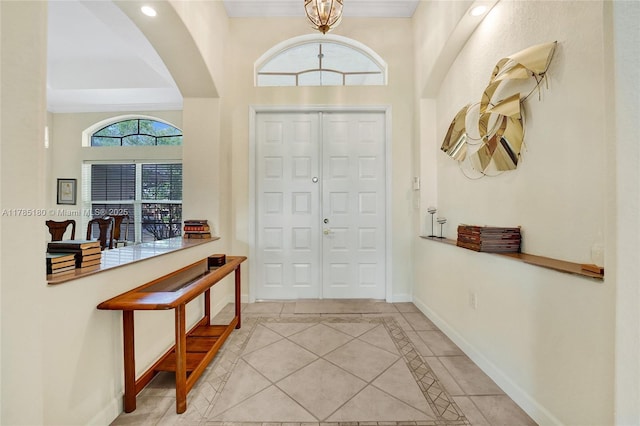 1951 NW 167th Ter, Pembroke Pines, FL 33028 - foyer featuring a towering ceiling, baseboards, arched walkways, and light tile patterned flooring