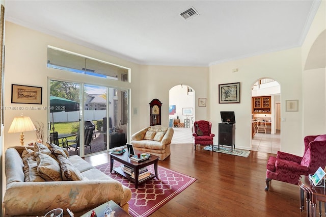 1951 NW 167th Ter, Pembroke Pines, FL 33028 - living area with arched walkways, crown molding, wood finished floors, and visible vents