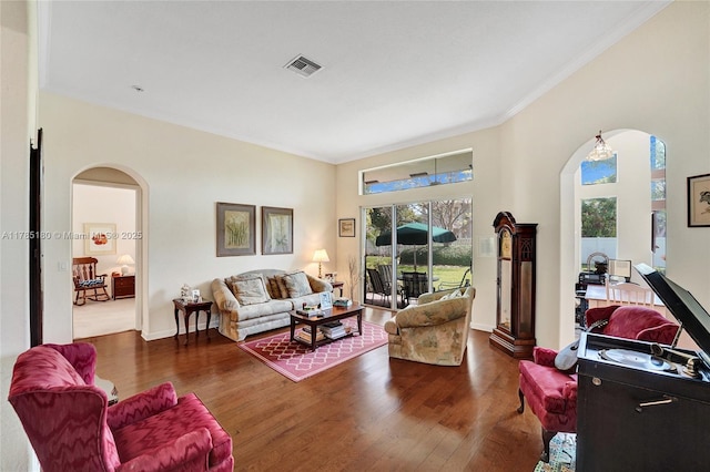 1951 NW 167th Ter, Pembroke Pines, FL 33028 - living area featuring arched walkways, wood finished floors, visible vents, and ornamental molding