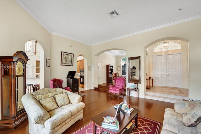 1951 NW 167th Ter, Pembroke Pines, FL 33028 - living area featuring wood finished floors, visible vents, arched walkways, and crown molding