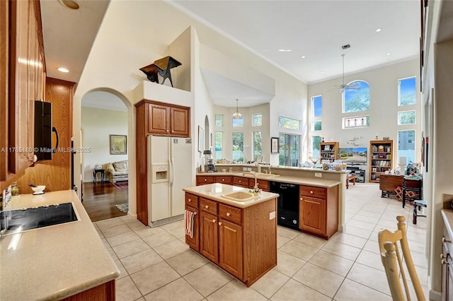 1951 NW 167th Ter, Pembroke Pines, FL 33028 - kitchen with brown cabinets, dishwasher, a sink, light tile patterned flooring, and white fridge with ice dispenser