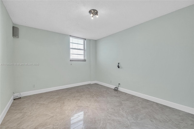 90 Edgewater Dr Unit 624, Coral Gables, FL 33133 - unfurnished room with baseboards and a textured ceiling