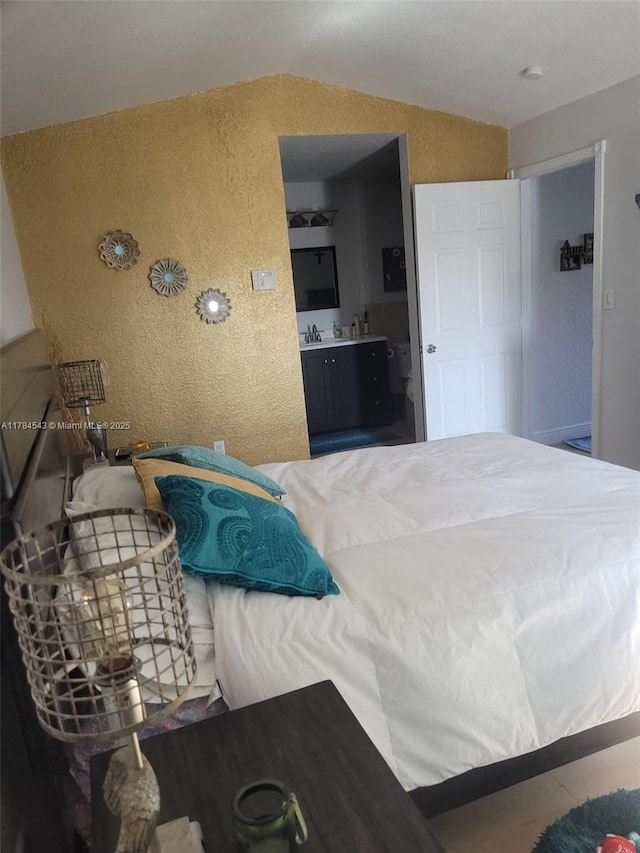 13799 SW 147th Cir Ln Unit 3, Miami, FL 33186 - bedroom with a textured wall, vaulted ceiling, and ensuite bathroom