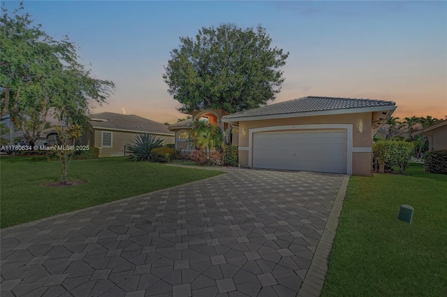 11257 NW 51st St, Coral Springs, FL 33076 - view of front of property featuring a tiled roof, stucco siding, decorative driveway, a front lawn, and a garage