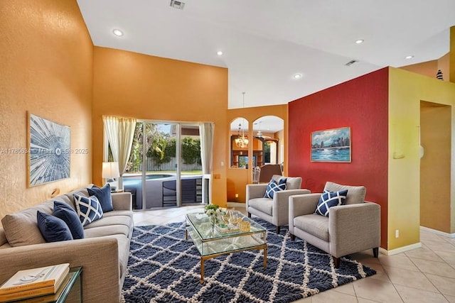11257 NW 51st St, Coral Springs, FL 33076 - living room featuring a towering ceiling, baseboards, recessed lighting, light tile patterned floors, and arched walkways