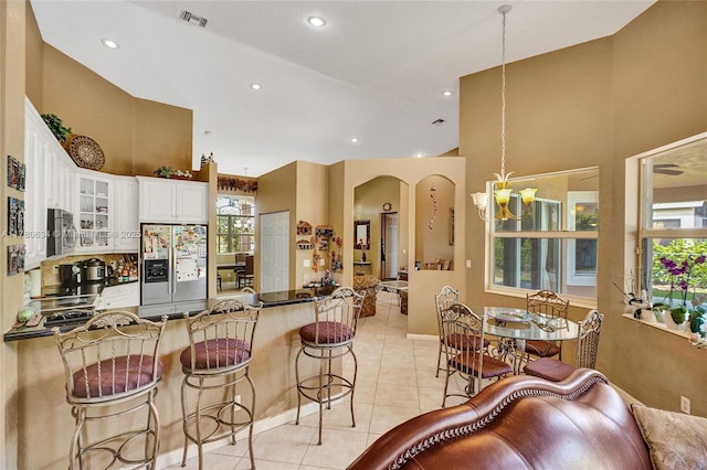 11257 NW 51st St, Coral Springs, FL 33076 - kitchen featuring visible vents, arched walkways, appliances with stainless steel finishes, a chandelier, and a peninsula