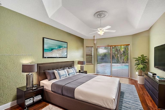 11257 NW 51st St, Coral Springs, FL 33076 - bedroom featuring a raised ceiling, ceiling fan, a textured wall, wood finished floors, and access to outside