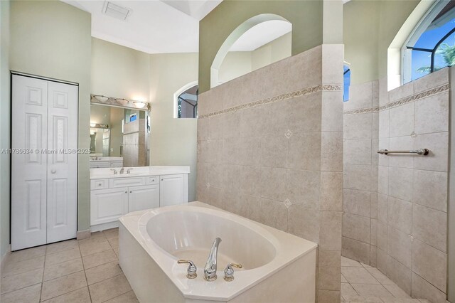 11257 NW 51st St, Coral Springs, FL 33076 - full bathroom with visible vents, a closet, vanity, tile patterned flooring, and a garden tub