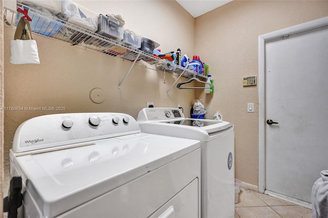 11257 NW 51st St, Coral Springs, FL 33076 - laundry room with washer and dryer, laundry area, light tile patterned floors, and baseboards