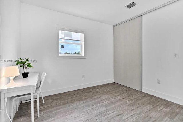 office featuring light wood-style flooring, baseboards, and visible vents