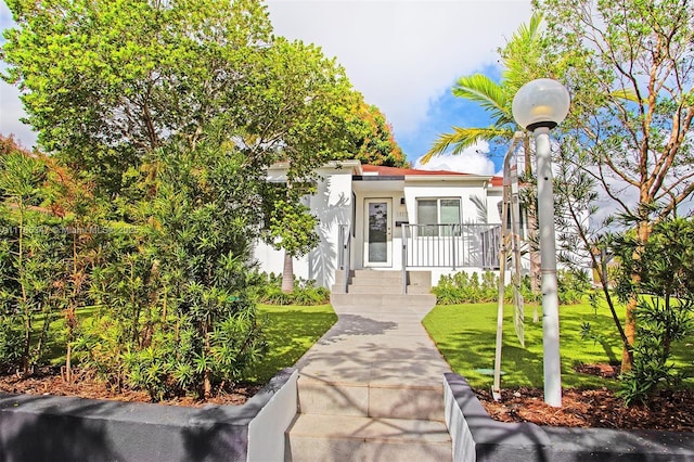 view of front of house with a front lawn and stucco siding