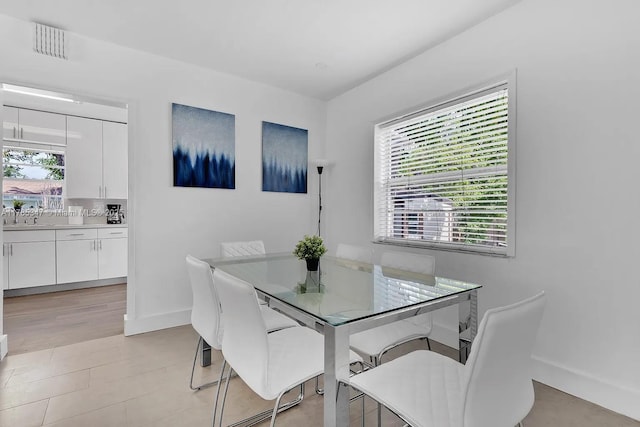 dining area with baseboards and visible vents
