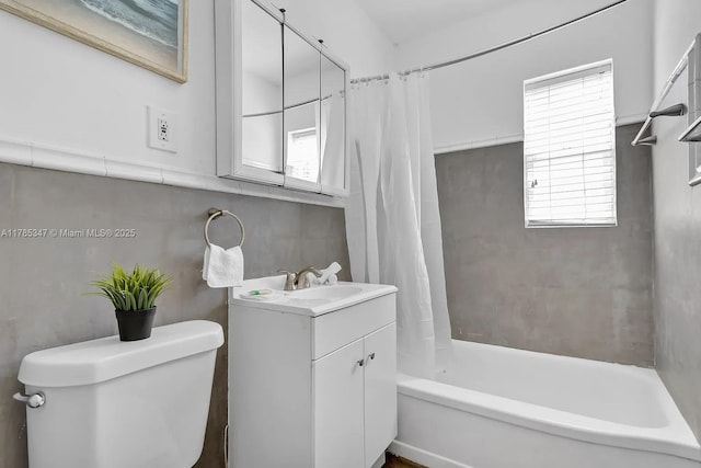 full bathroom with toilet, shower / tub combo, a healthy amount of sunlight, and vanity