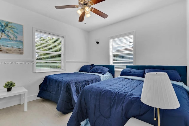 bedroom with a ceiling fan and tile patterned flooring