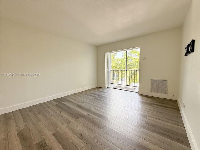 1601 S Flagler Dr Unit 211O, West Palm Beach, FL 33401 - unfurnished room featuring wood finished floors, visible vents, and baseboards
