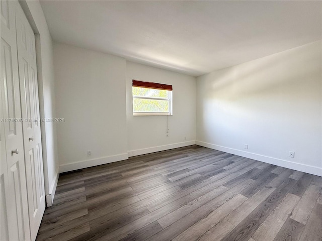 1601 S Flagler Dr Unit 211O, West Palm Beach, FL 33401 - empty room featuring baseboards and dark wood-type flooring