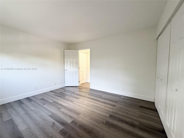 1601 S Flagler Dr Unit 211O, West Palm Beach, FL 33401 - unfurnished bedroom with dark wood finished floors, a closet, and baseboards
