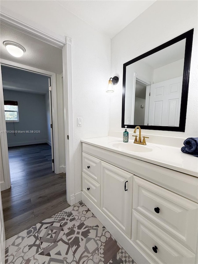 1601 S Flagler Dr Unit 211O, West Palm Beach, FL 33401 - bathroom with baseboards, vanity, and wood finished floors