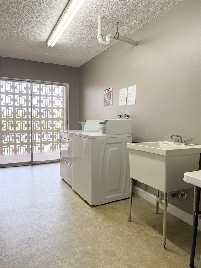 1601 S Flagler Dr Unit 211O, West Palm Beach, FL 33401 - washroom with washing machine and dryer, a textured ceiling, and a sink