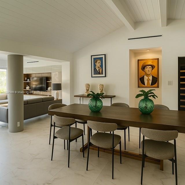 1141 NE 90th St, Miami, FL 33138 - dining area featuring marble finish floor and vaulted ceiling with beams