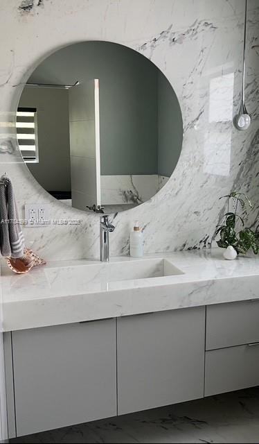 1141 NE 90th St, Miami, FL 33138 - bathroom featuring vanity and marble finish floor