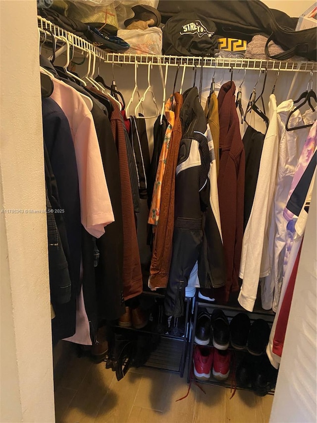 202 Lake Pointe Dr Unit 105, Oakland Park, FL 33309 - walk in closet featuring wood finished floors