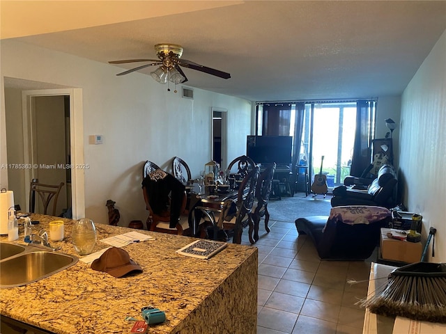 202 Lake Pointe Dr Unit 105, Oakland Park, FL 33309 - living area with light tile patterned floors and ceiling fan