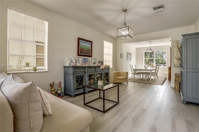 4322 Fox Ridge Dr, Weston, FL 33331 - living area with light wood-style flooring and a chandelier
