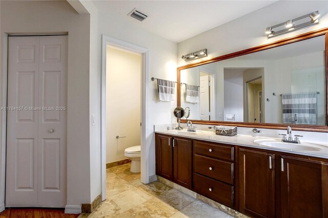 4322 Fox Ridge Dr, Weston, FL 33331 - bathroom featuring a closet, double vanity, toilet, and baseboards