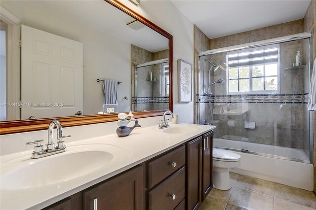 4322 Fox Ridge Dr, Weston, FL 33331 - bathroom with toilet, double vanity, shower / bath combination with glass door, and tile patterned floors