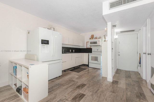 3401 N Country Club Dr Unit 117, Aventura, FL 33180 - kitchen featuring light wood-style floors, white appliances, and visible vents