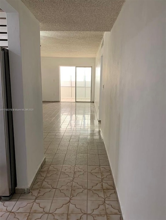 1810 W 56th St Unit 3127, Hialeah, FL 33012 - corridor with a textured ceiling and light tile patterned floors