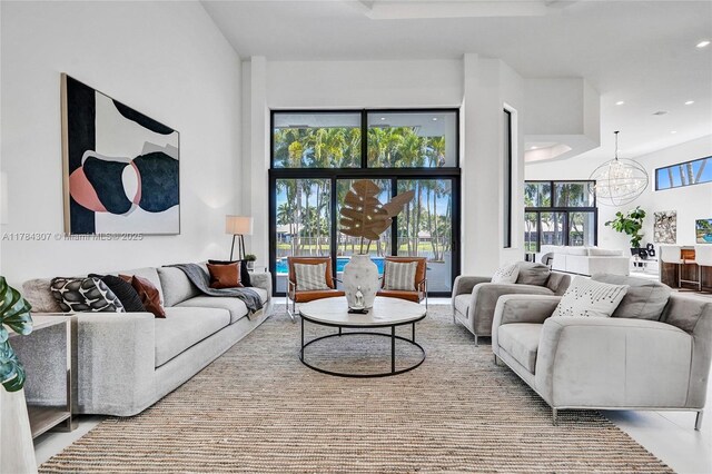 living room with recessed lighting and a notable chandelier
