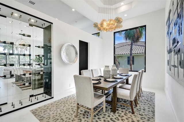 dining room featuring a chandelier, baseboards, visible vents, and recessed lighting