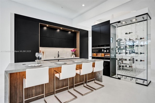 bar with indoor wet bar and a sink