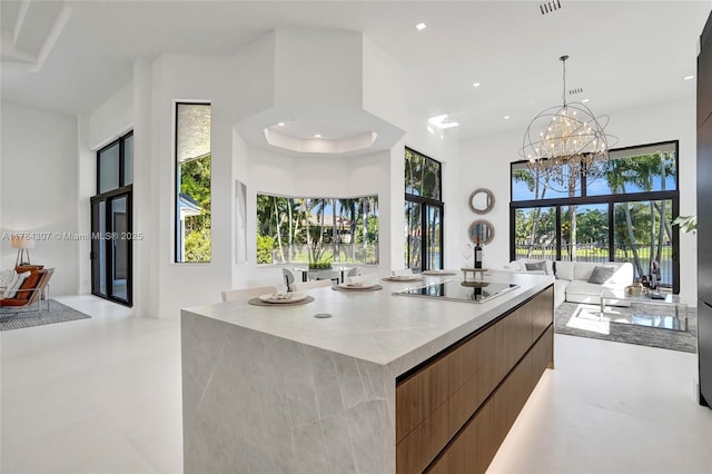 kitchen with a wealth of natural light, recessed lighting, black electric stovetop, and modern cabinets