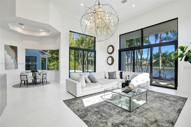 living room featuring plenty of natural light, recessed lighting, and a high ceiling