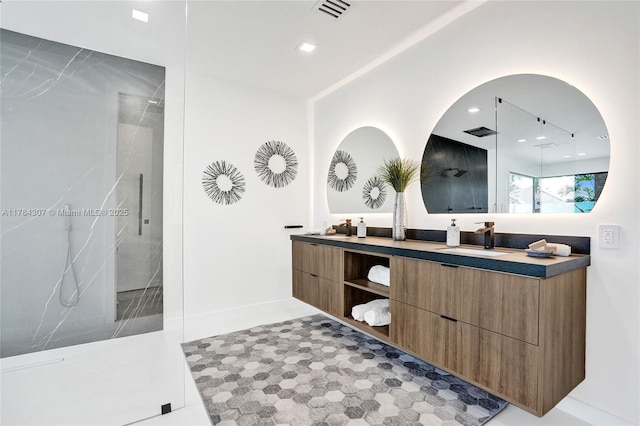 bathroom with walk in shower, double vanity, a sink, and visible vents