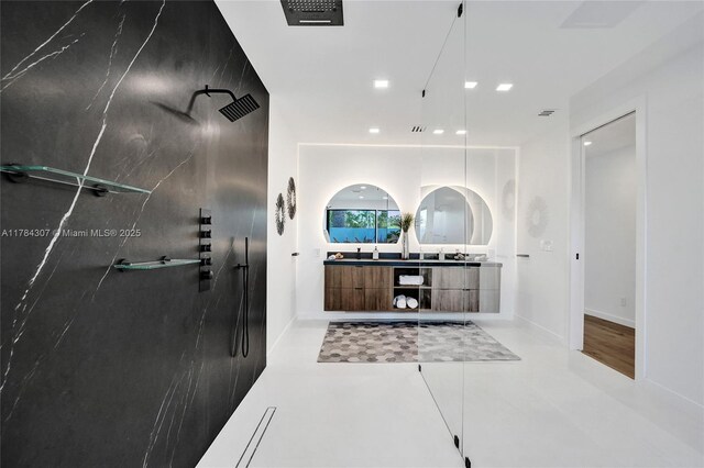 full bathroom with recessed lighting, double vanity, visible vents, baseboards, and walk in shower