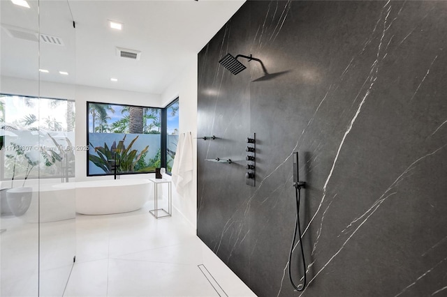 bathroom with tile patterned floors, a walk in shower, visible vents, and a freestanding bath