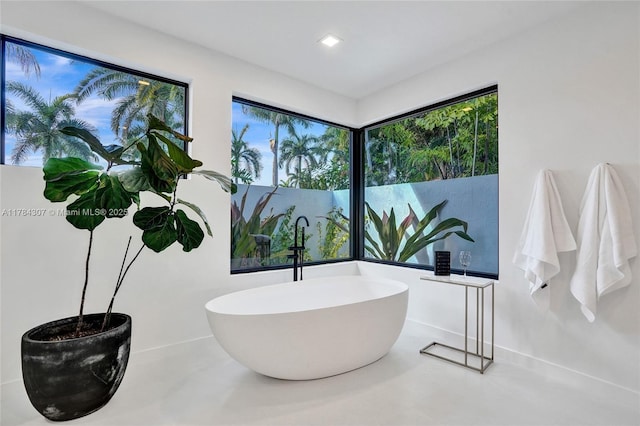 bathroom with a sink and a soaking tub