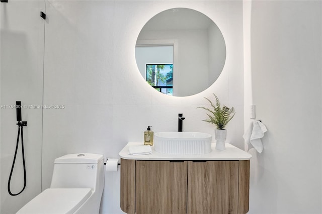 bathroom with toilet and vanity