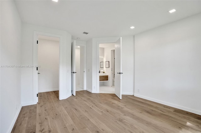 unfurnished bedroom featuring visible vents, baseboards, recessed lighting, and light wood-style floors