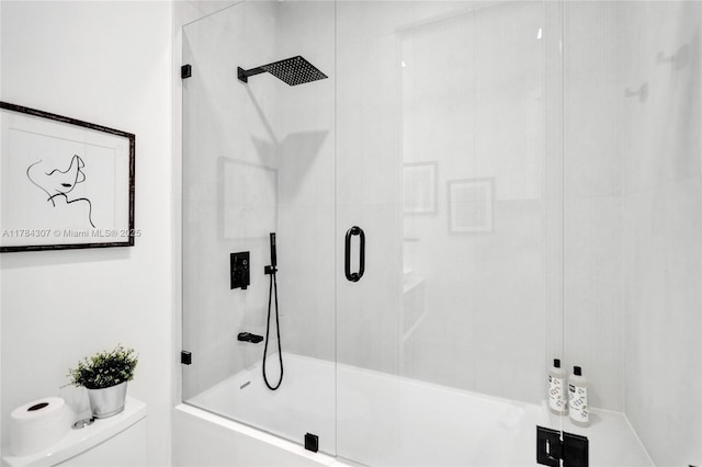 full bath featuring bath / shower combo with glass door and toilet