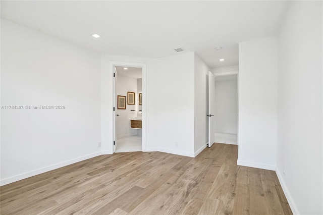 unfurnished room with recessed lighting, visible vents, baseboards, and light wood-type flooring
