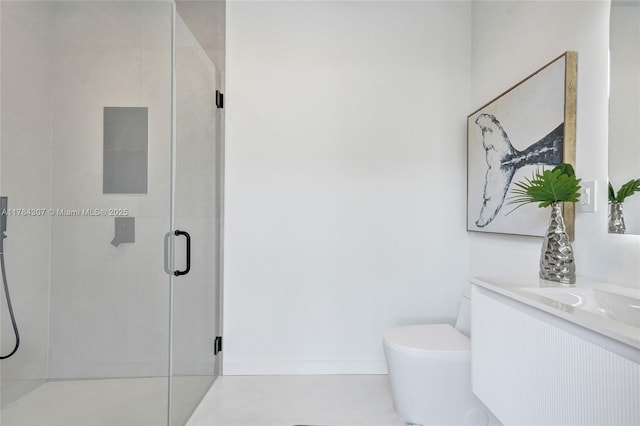 full bathroom featuring a stall shower, toilet, and vanity