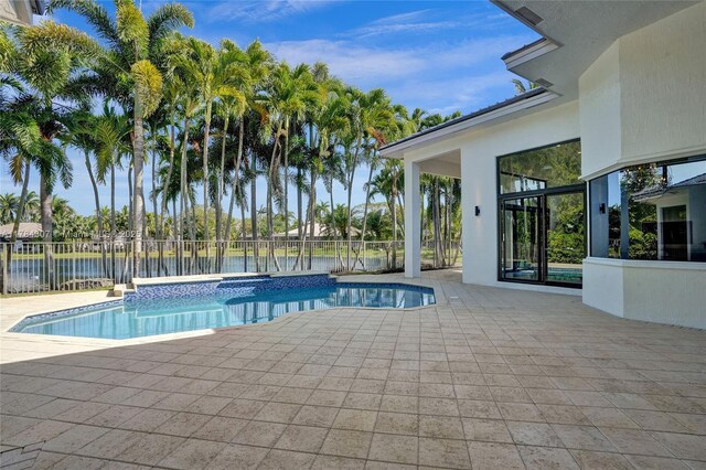 view of pool featuring a fenced backyard, a water view, a patio, and a fenced in pool