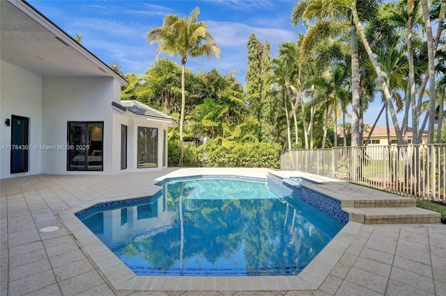view of swimming pool featuring fence, a fenced in pool, and a patio area