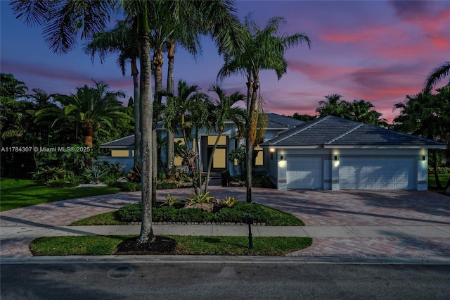 view of front of house featuring decorative driveway and an attached garage