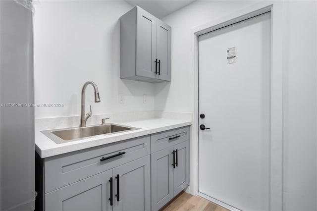 washroom featuring a sink and light wood-style flooring